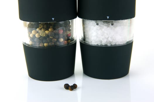 Electric salt and pepper grinders isolated on white