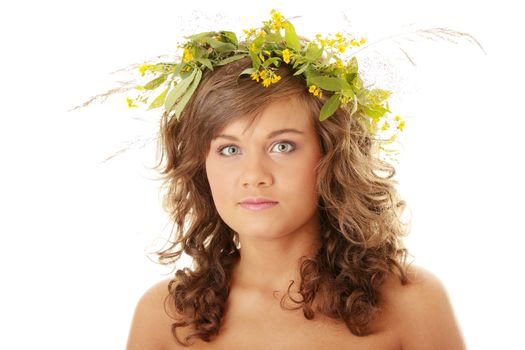 Young woman on the isolated background, a wreath from flowers on a head
