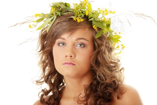 Young woman on the isolated background, a wreath from flowers on a head