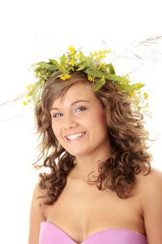 Young woman on the isolated background, a wreath from flowers on a head