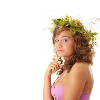 Young woman on the isolated background, a wreath from flowers on a head