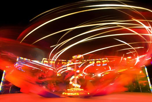 Blur neon lights in amusement park, long exposure