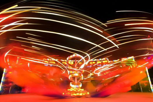 Blur neon lights in amusement park, long exposure