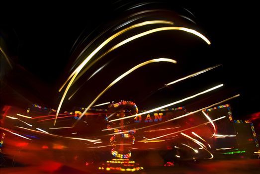 Blur neon lights in amusement park, long exposure