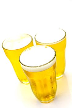 Glasses of beer isolated against a white background