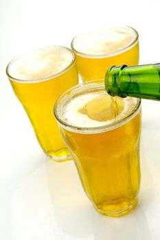 Glasses of beer isolated against a white background