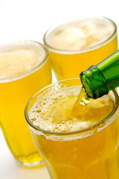 Glasses of beer isolated against a white background