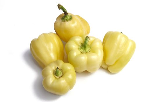Group of yellow peppers on white background
