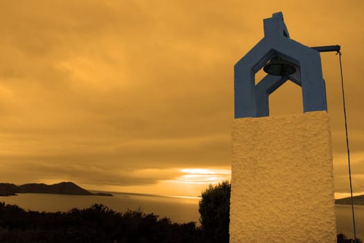 bell tower at sunset with scenic view in kerry ireland of coastline