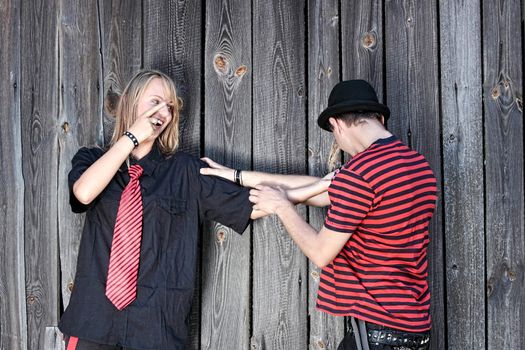 Punk couple against wood wall - street fashion