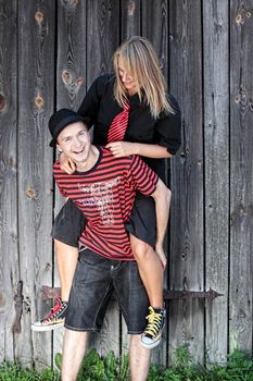 Punk couple against wood wall - street fashion