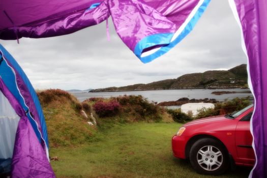 car and tent at campsite on the edge of the coast of kerry in ireland