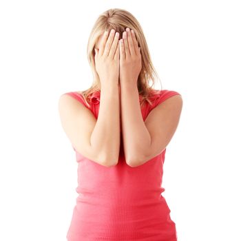 Isolate studio shot of a casually dressed young adult woman covering her eyes.