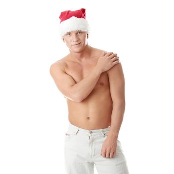 Sexy muscular man wearing a Santa Claus hat isolated on white