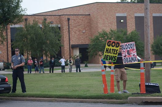 OKLAHOMA CITY, OK - SEPTEMBER 18, 2009: Members of the Westboro Baptist Church of Topeka, Kansas Demonstrate outside Temple B'nai Israel in Oklahoma City on September 18, 2009, the eve of the Jewish holiday Rosh Hashanah, while members of the temple congregation look on. 
