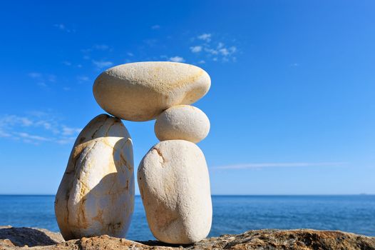 Pebble in balance between the two long boulders