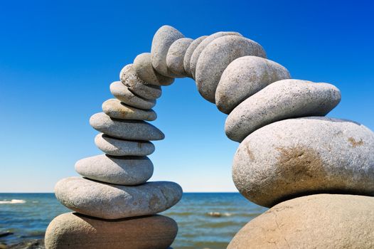 Arch of gravel against a background sea horizon