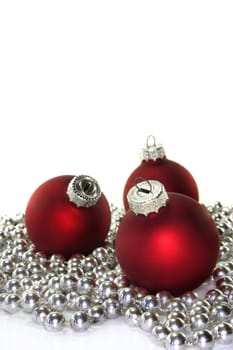 red Christmas balls and a pearl necklace