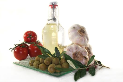 Olive oil with olive branch and fresh ingredients