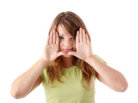 Closeup of beautiful young teenage woman making frame with her hands