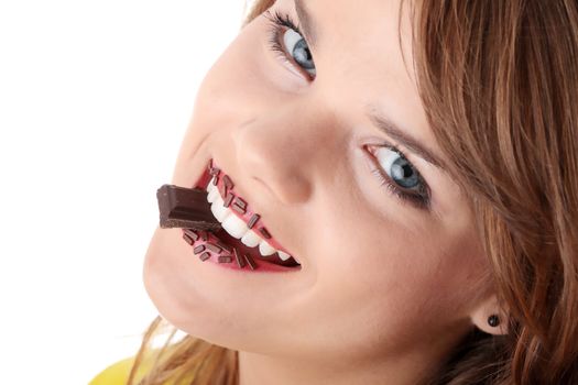 Teen girl eating chocolate isolated