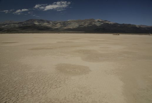 view of death valley with dry soil and mountains