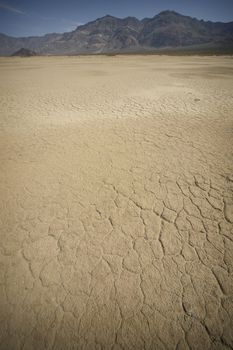 view of death valley with dry soil and mountains