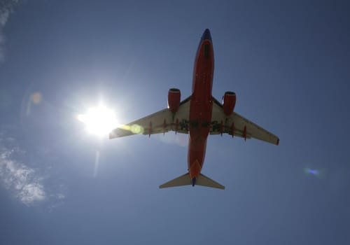 plane landing with blue sky in background