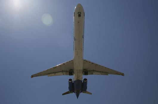 plane landing with blue sky in background