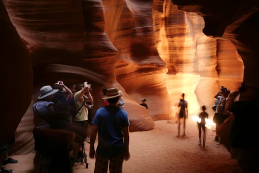 people taking pictures at the upper antelope canyon