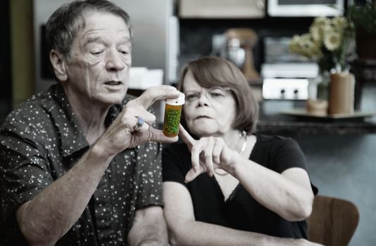 Couple at Home Considering Medication in Bottle