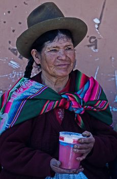 Cusco , Peru - May 27 : Peruvian woman drink "Chicha"  , "Chicha" is drink common throughout Latin America originated with the Incas , the photo was taken in Cusco Peru on May 27 2011