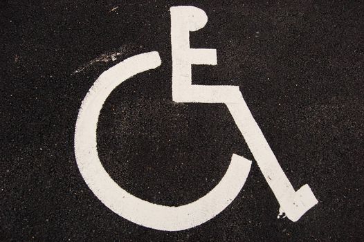 Parking place for handicapped. Sign painted on asphalt