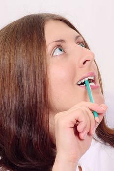 The nice girl with a pencil looking upwards