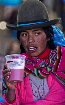 Cusco , Peru - May 27 : Peruvian woman drink "Chicha"  , "Chicha" is drink common throughout Latin America originated with the Incas , the photo was taken in Cusco Peru on May 27 2011