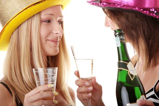 Two casual young women enjoying champagne in new yers eve