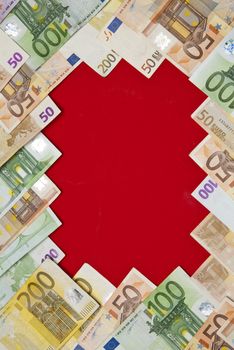 Euro bills on red background,recorded above them.