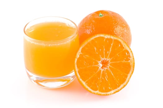 Oranges and a glass of fresh orange juice, isolated on white.