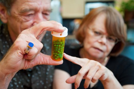 Senior couple at home with prescription bottle