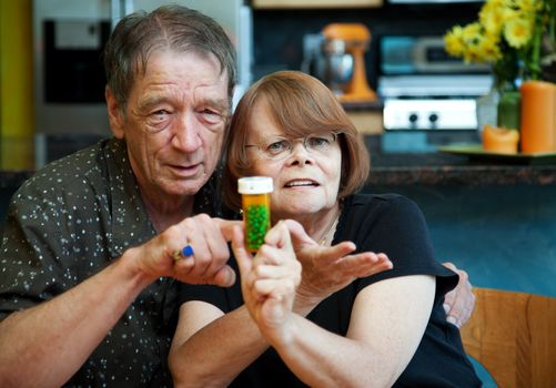 Senior couple at home with prescription bottle