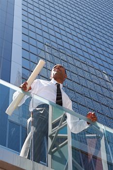 An Arfican-American young urban professional architect surveying the city