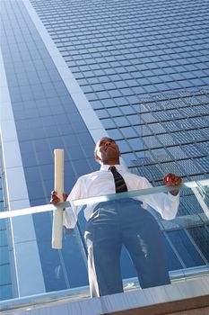 An Arfican-American young urban professional architect surveying the city