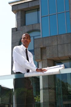 An Arfican-American young urban professional architect surveying the city