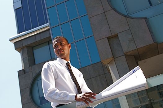 An Arfican-American young urban professional architect surveying the city