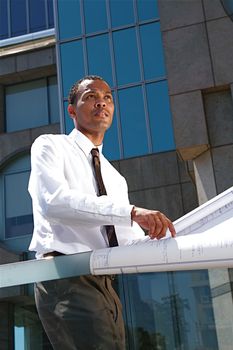 An Arfican-American young urban professional architect surveying the city