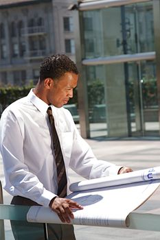 An Arfican-American young urban professional architect surveying the city