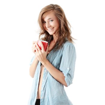 The beautiful young woman drinks morning coffee or tea