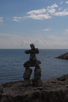 inukshuk statue or monument by the lake