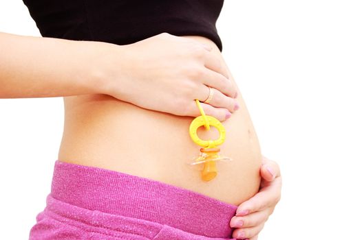 Woman's pregnant belly and dummy over white