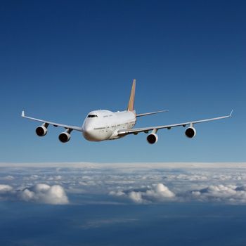 An Airliner in Flight over Clouds